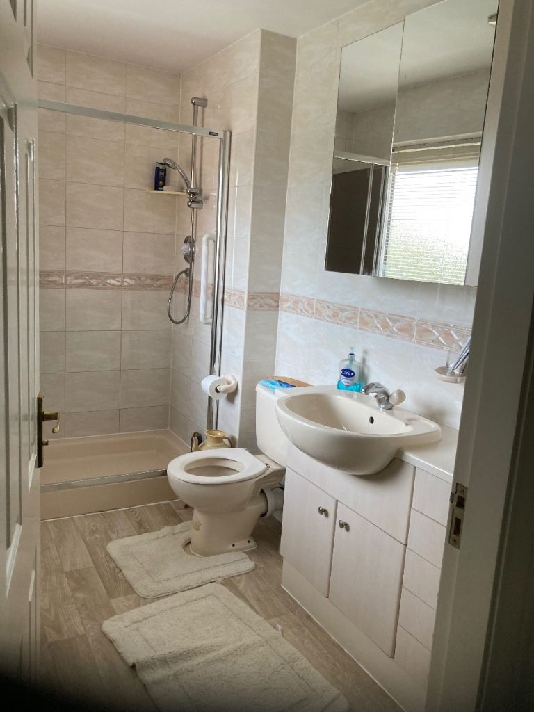 Bifold shower door by Showerlux and side panel 