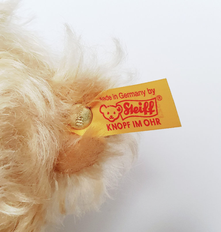 Steiff Bear with Bow and tag with gold plated button. Approx 12 inches