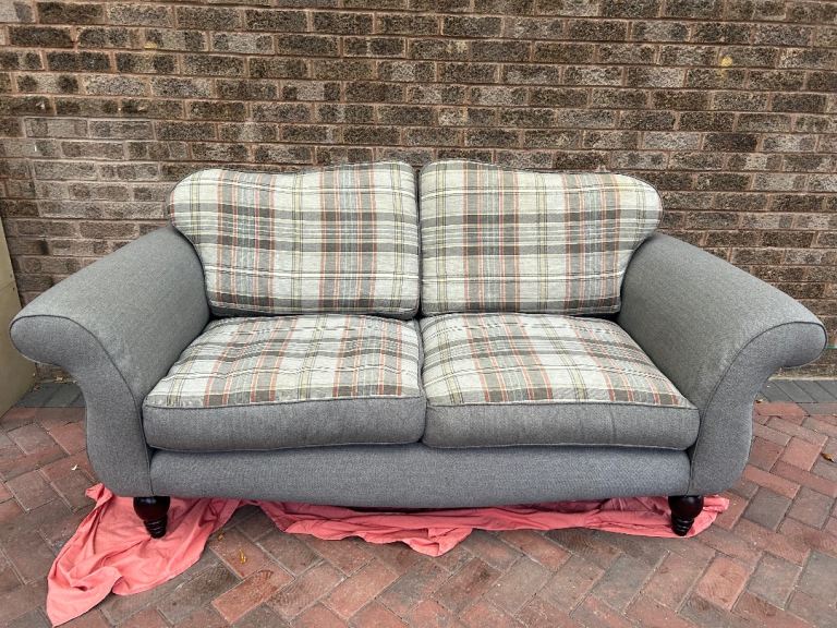 Cosy Two-Seater Sofa in Grey with Plaid Cushions – Good Condition