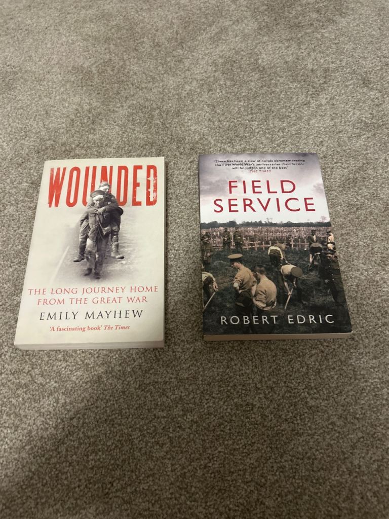 Two World War themed books: 'Wounded' and 'Field Service'