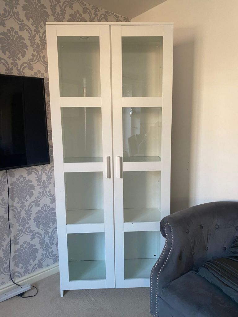 IKEA’s tall white glass-door display/bookcase style