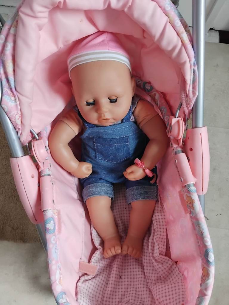 Dolls pink pram with doll and covers sweet shop,jigsaw,few other toys 