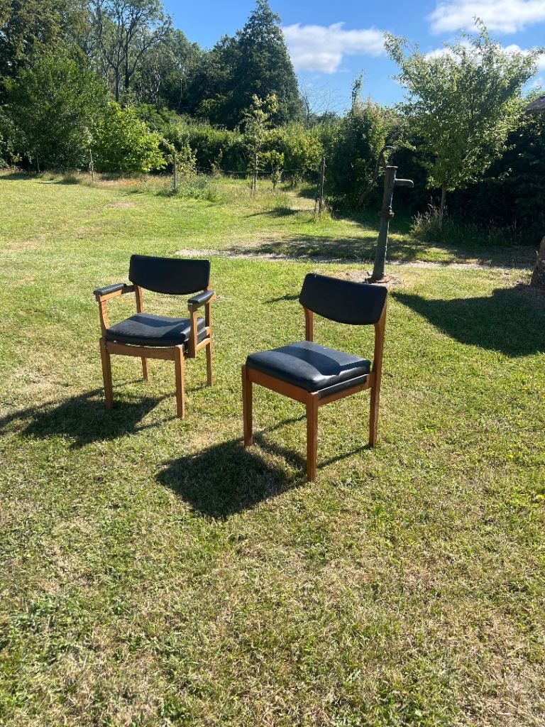 Pair of mid century vinyl and teak upholstered chairs 