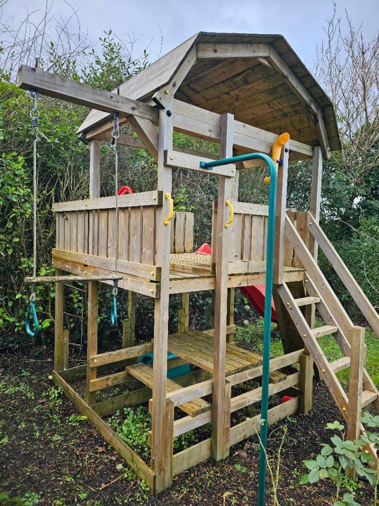 Kid's climbing frame/treehouse with slide, pole, climbing wall and swing attachment