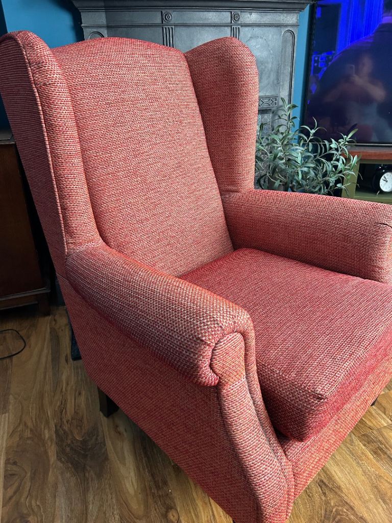 Red Wingback Armchair excellent condition with fire label attached