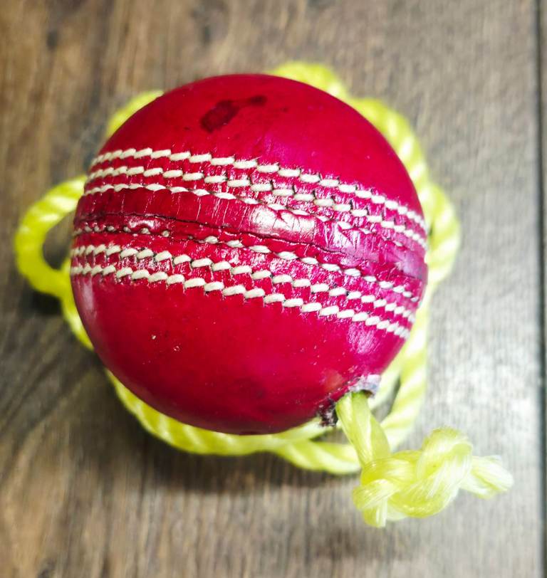 Red Cricket Ball on a String – Good Condition