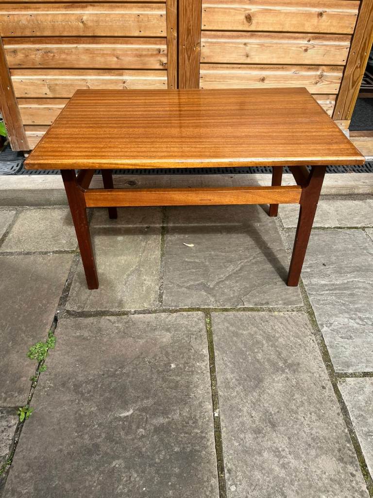 A four legged medium size rectangular wooden coffee table.