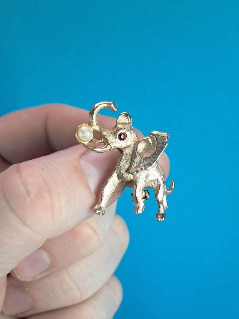 vintage gold-tone elephant brooch, often referred to as a "lucky" brooch.