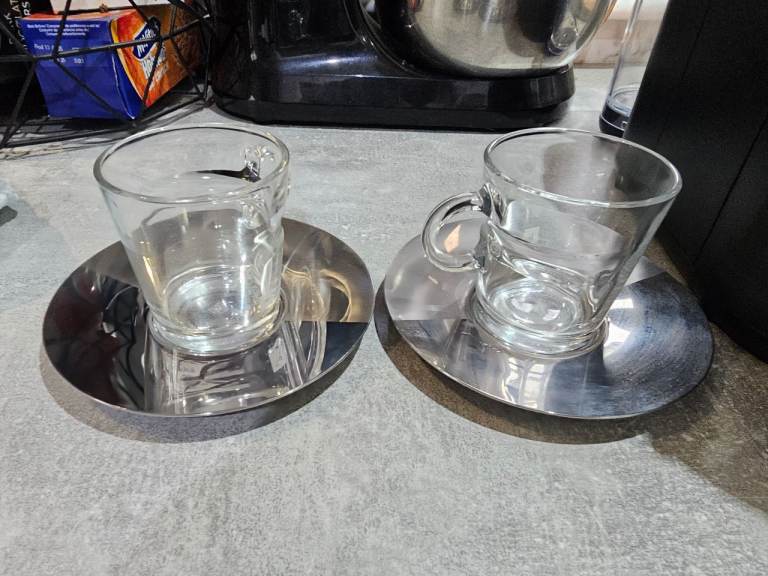 Nespresso veturo pod coffee maker machine in white with Nespresso cups/saucers, storage jar and pods