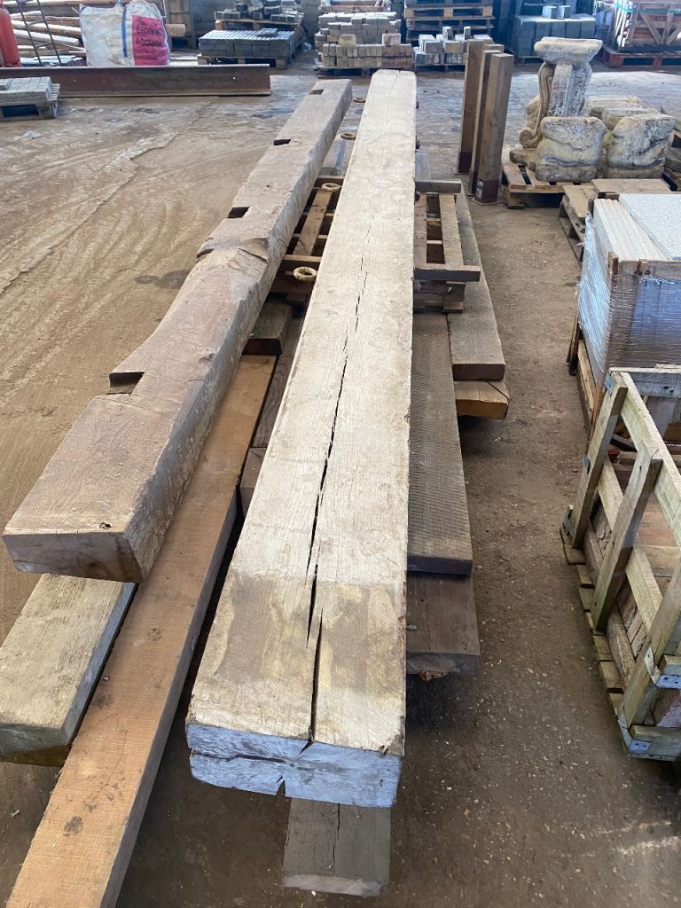 LARGE ANTIQUE 6.4M SOLID OAK BEAM WITH ORIGINAL HANGING HOOKS.