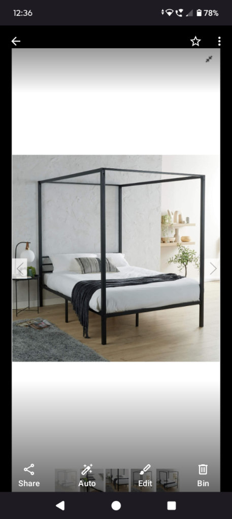 Black metal four poster double bed