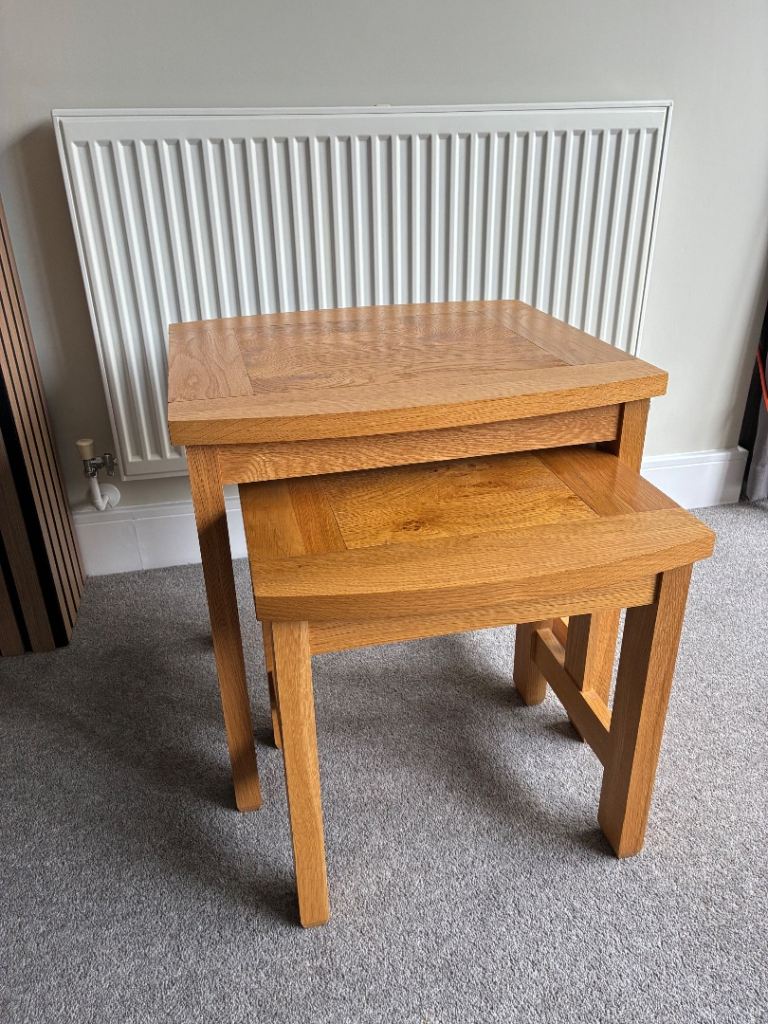 A lovely nest of two oak veneer John Lewis Burford tables  perfect for a living room or lounge