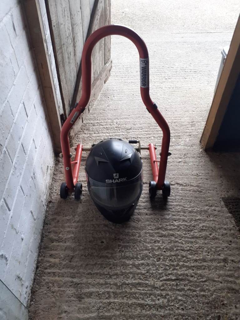 Warrior motorbike stand and crash helmet