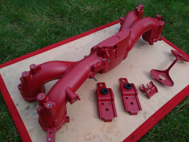 Subaru Impreza WRX Intake manifold + upper radiator support brackets + battery clamp bracket.