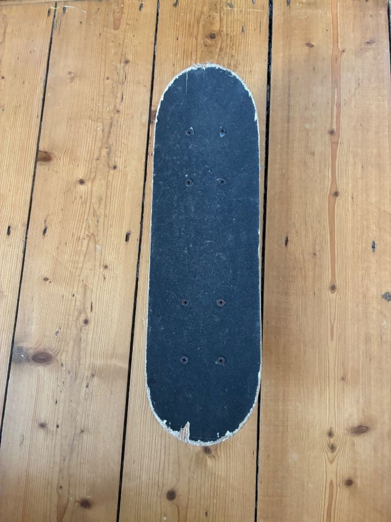 Skateboard with Skull Design – Good Condition