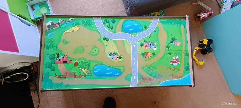 Wooden table with farm and roads on the top