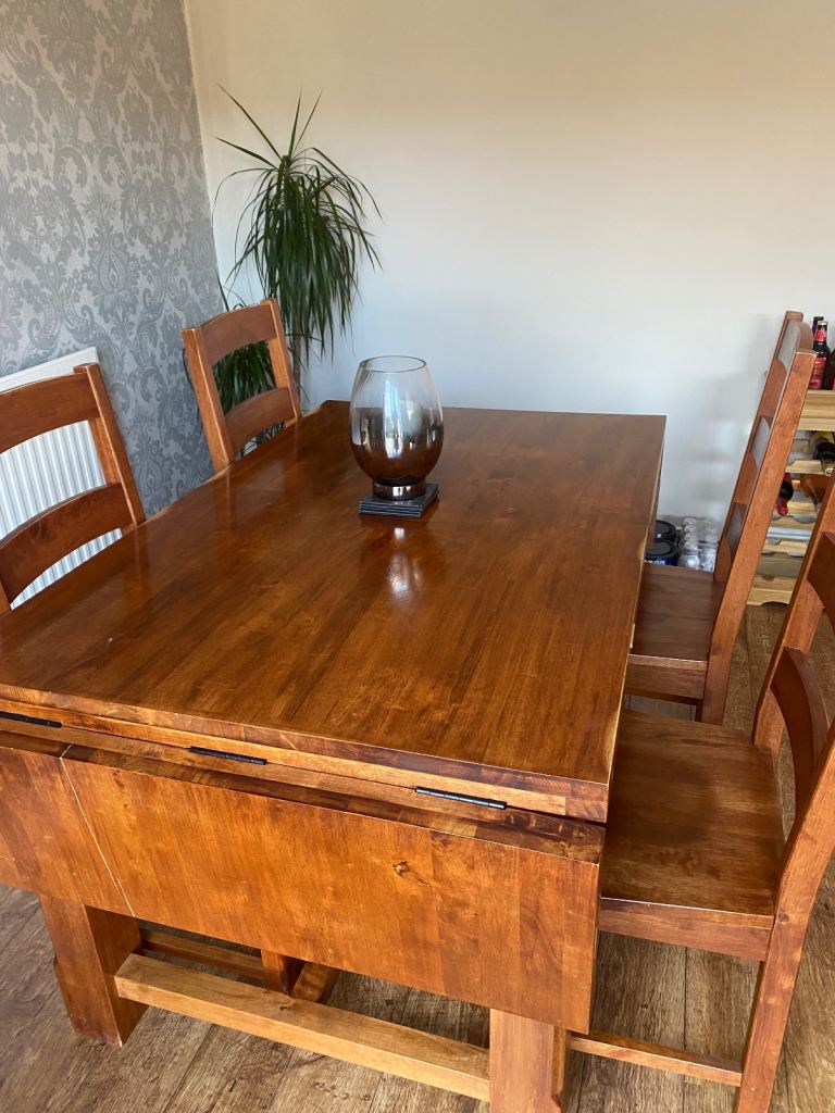 Solid wood table and four matching chairs. 
