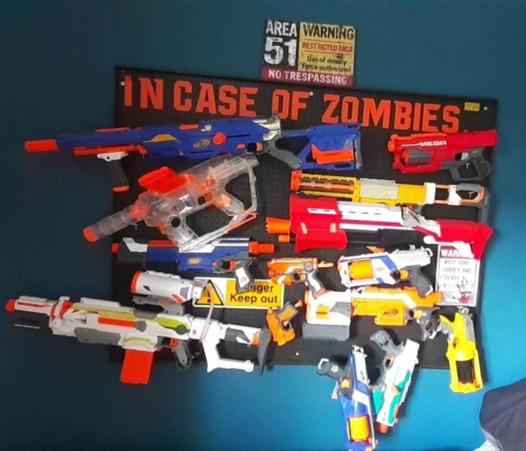 Large Collection of Nerf Guns with display wall