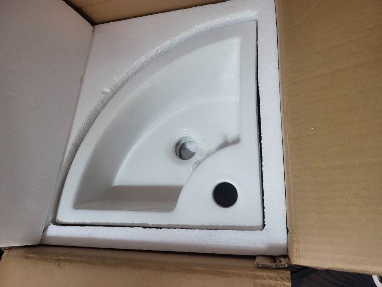 white ceramic wall-mounted corner wash basin