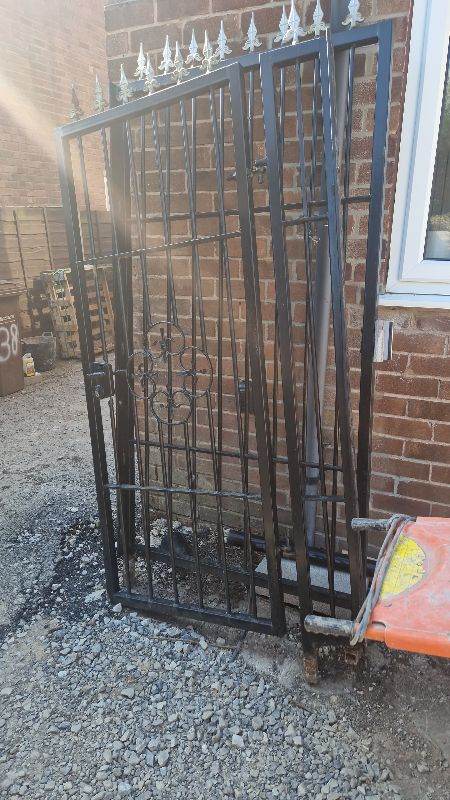 Black metal garden gate and side panel