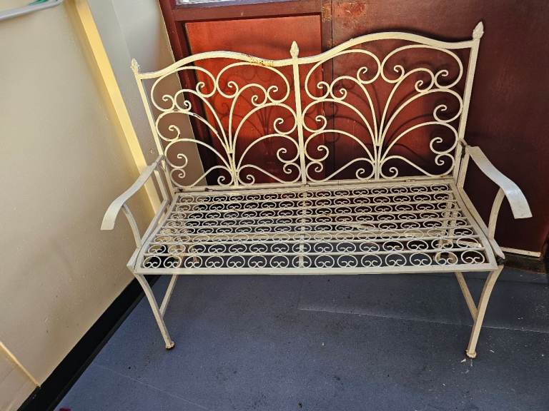 Antique folding wrought iron couples seat.