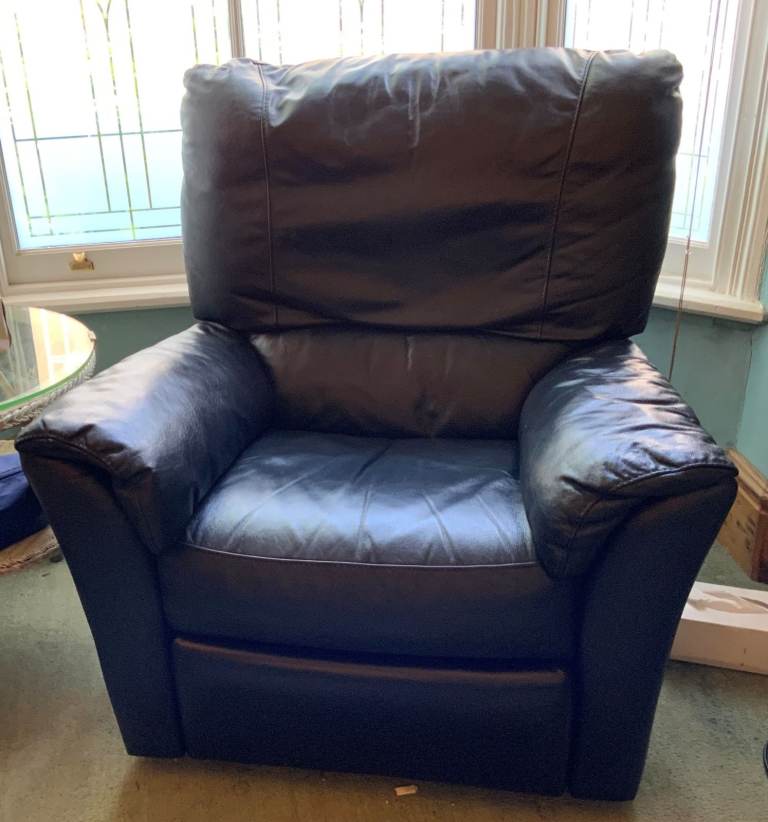 IKEA VINTAGE navy blue leather lazy-boy recliner chair with foot lift operated by a lever.