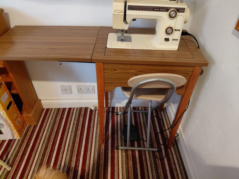 Multi task sewing machine with fold away table.
