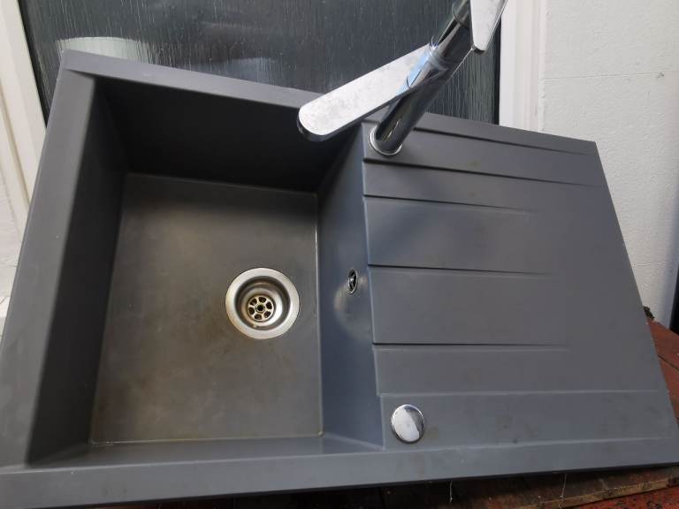 Kitchen sink and chrome tap