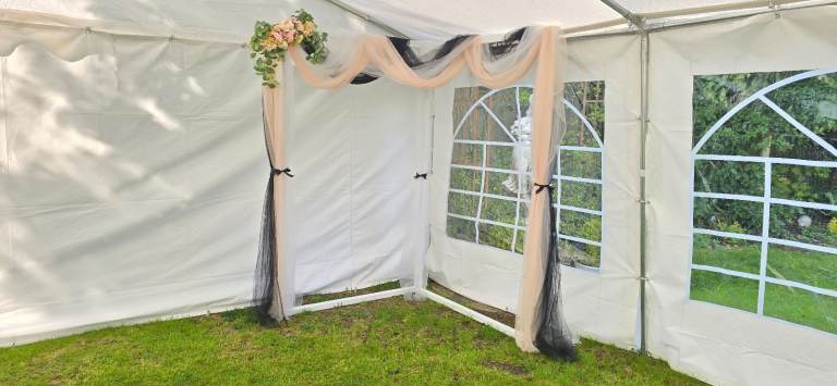 Wedding arch backdrop floral voil display.