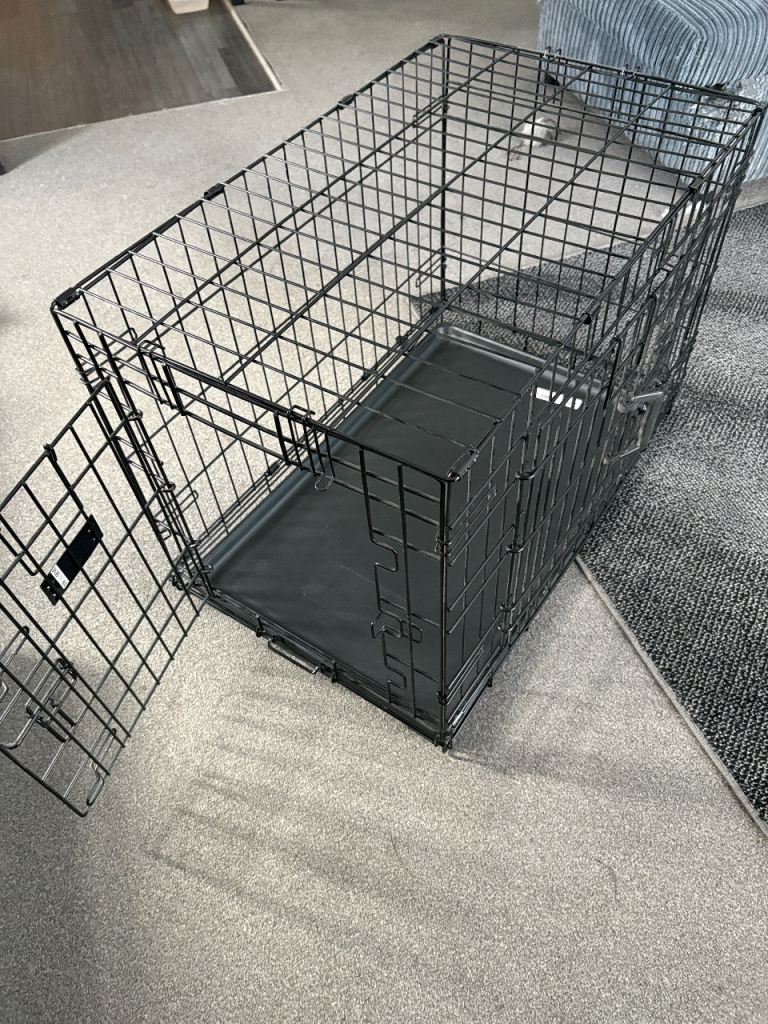 Black metal dog crate with plastic tray, suitable for medium to large dogs