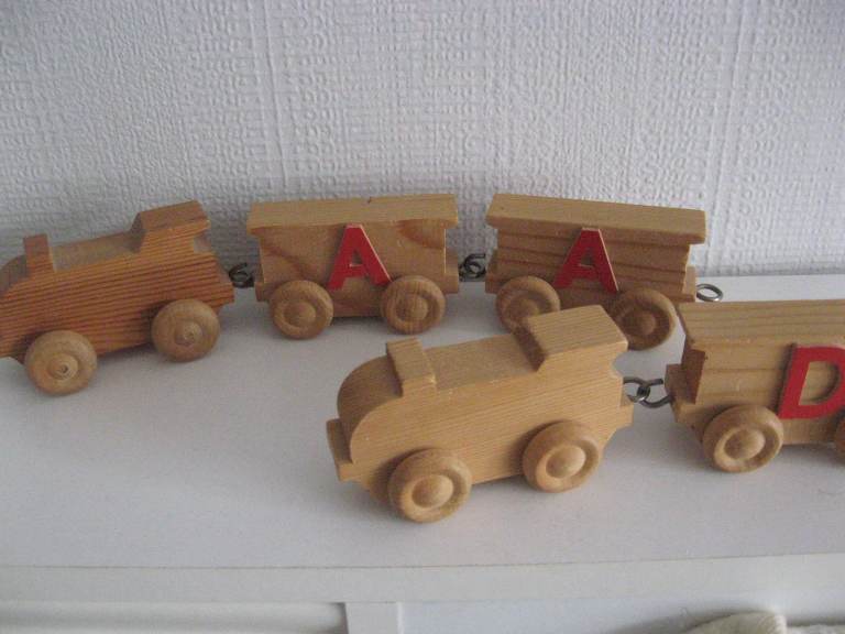 small wooden childs push along small train and carriages