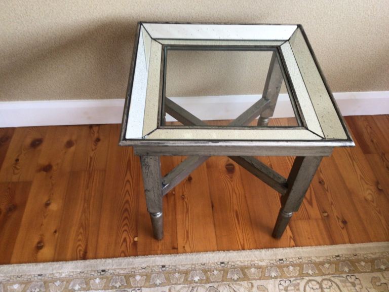 Glass top and mirrored edged table