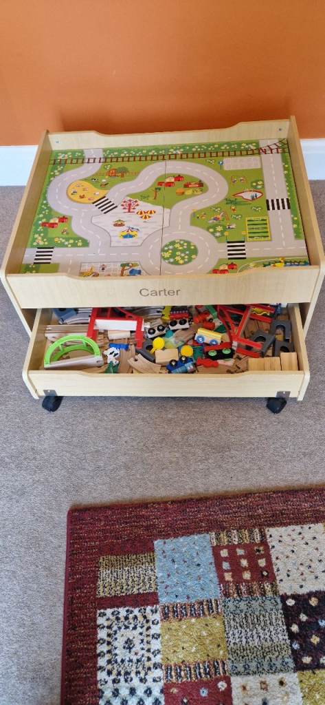 WOODEN PLAY TABLE PLUS WOODEN TRAIN TRACK AND TWO TRAINS. VERY GOOD CONDITION.