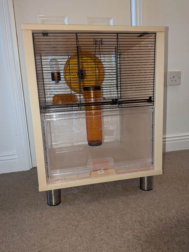 Gerbil cage with food and wood shavings