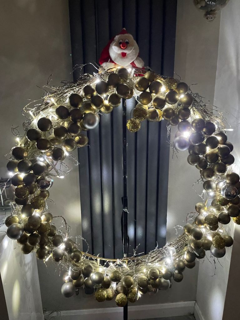 Large metal Christmas wreath with lights and baubles