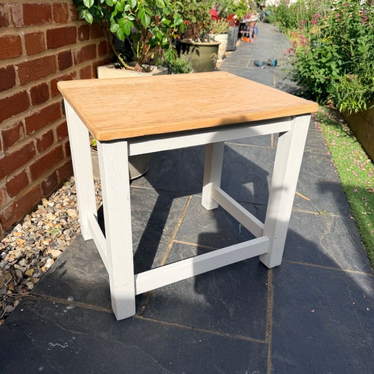 Solid wood coffee/side table with pine top and painted cream legs. 