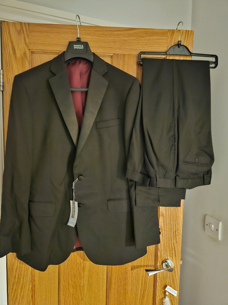 M&S Black long suit jacket with black trousers with suit bag.