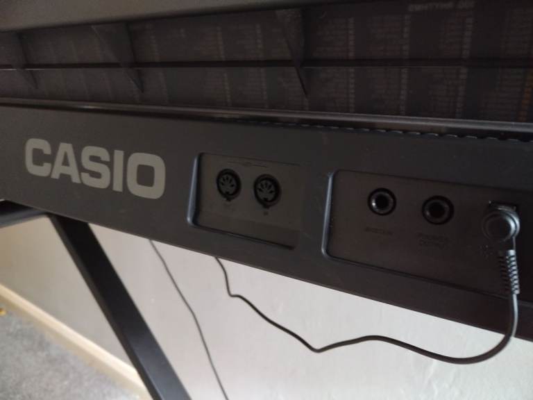 Electric keyboard Casio with power lead and stand in very good condition good working order 