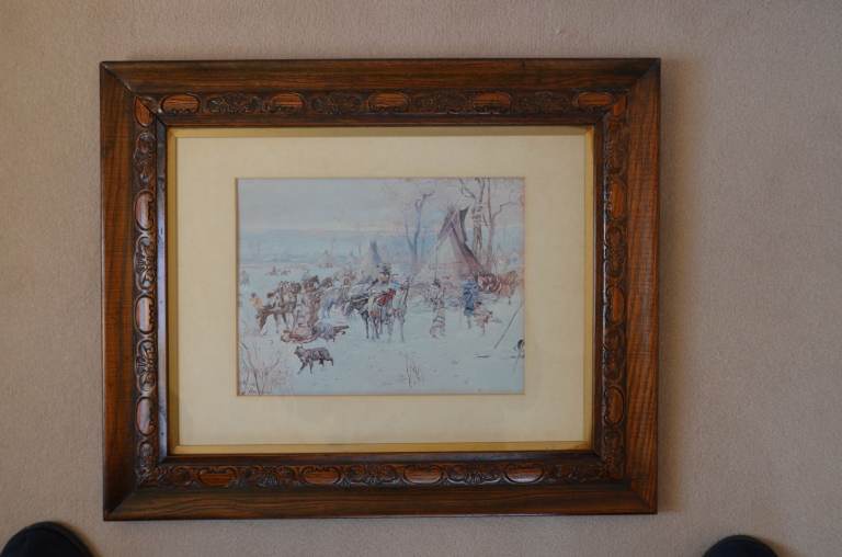 Antique oak framed Vintage CM Russell print of plains indian hunters' return to winter camp.