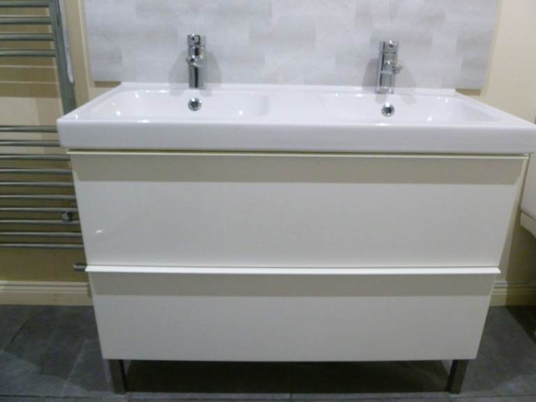 Bathroom vanity unit with double sink and taps