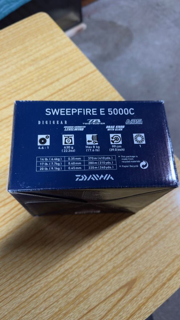 DAIWA SWEEPFIRE E 5000C spinning reel, loaded with braid.