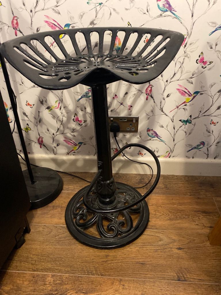 Black metal tractor seat bar stool. 