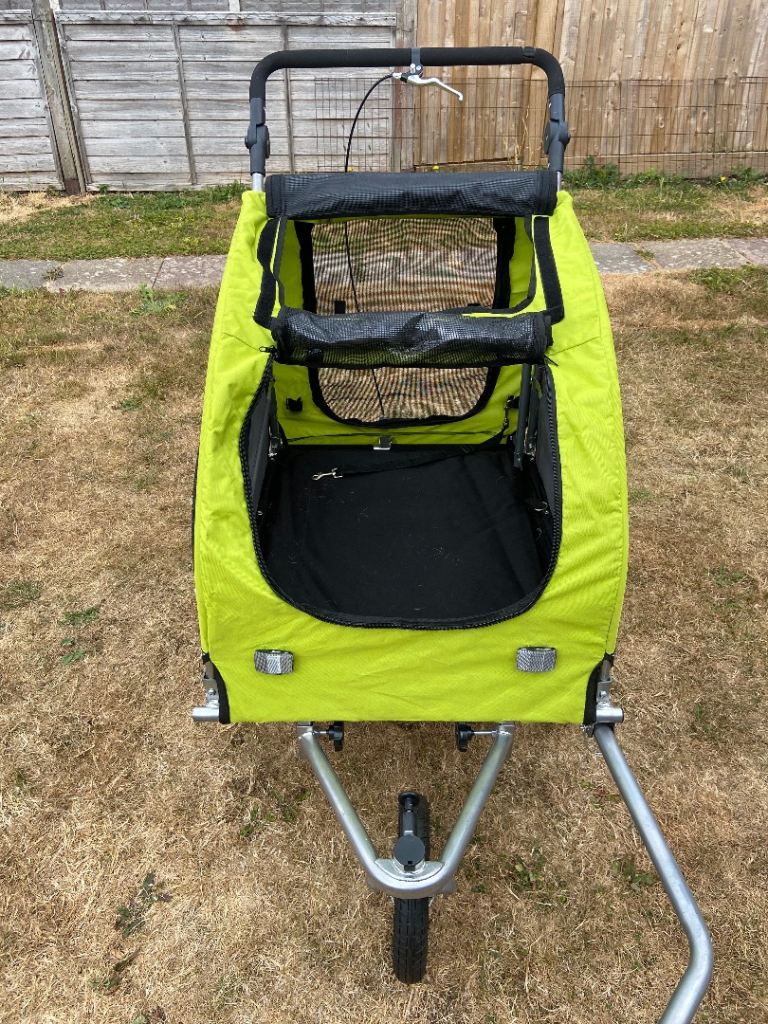 Sturdy green bicycle trailer / stroller with handle, hitch, brakes and suspension.