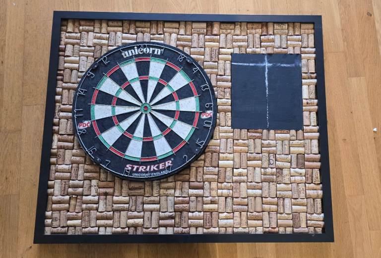 Dart board with cork frame