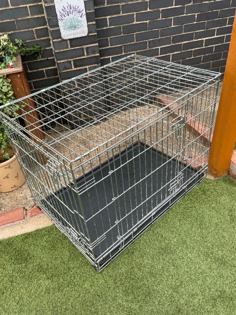 Large dog crate with removable tray and two doors in good condition 