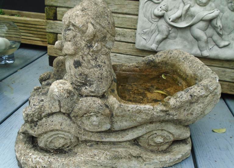 Old reconstituted stone garden ornament bird bath, gnome in car