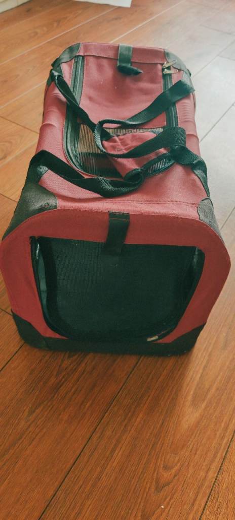 Red and black soft-sided pet carrier for small animals