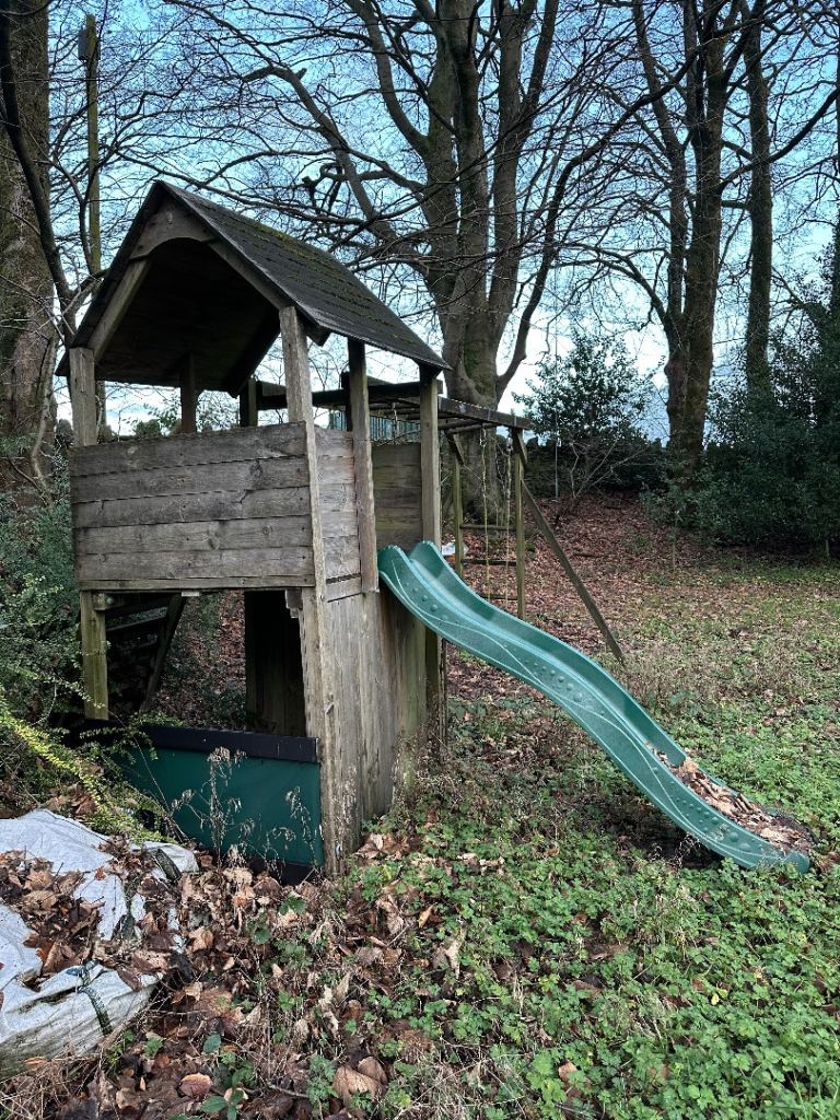 Wooden climbing frame, swings and slide