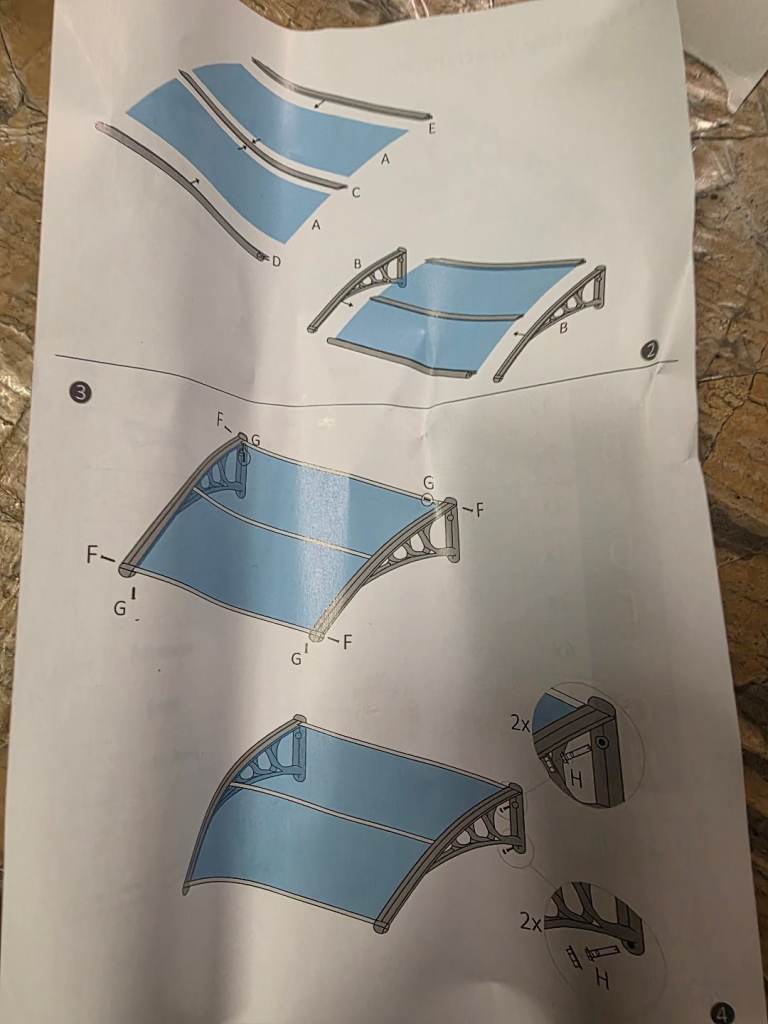 A new single over door canopy in black and clear plastic the measurements 