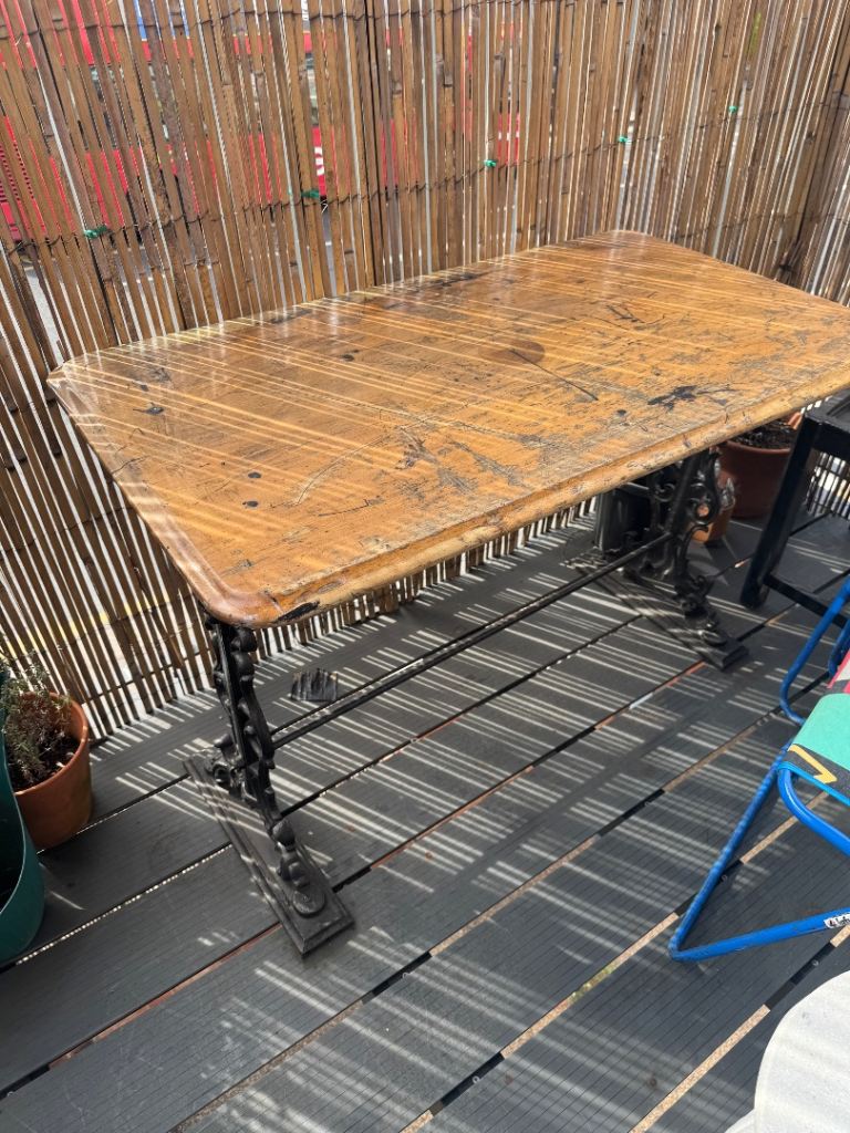 Outdoor table with cast iron legs